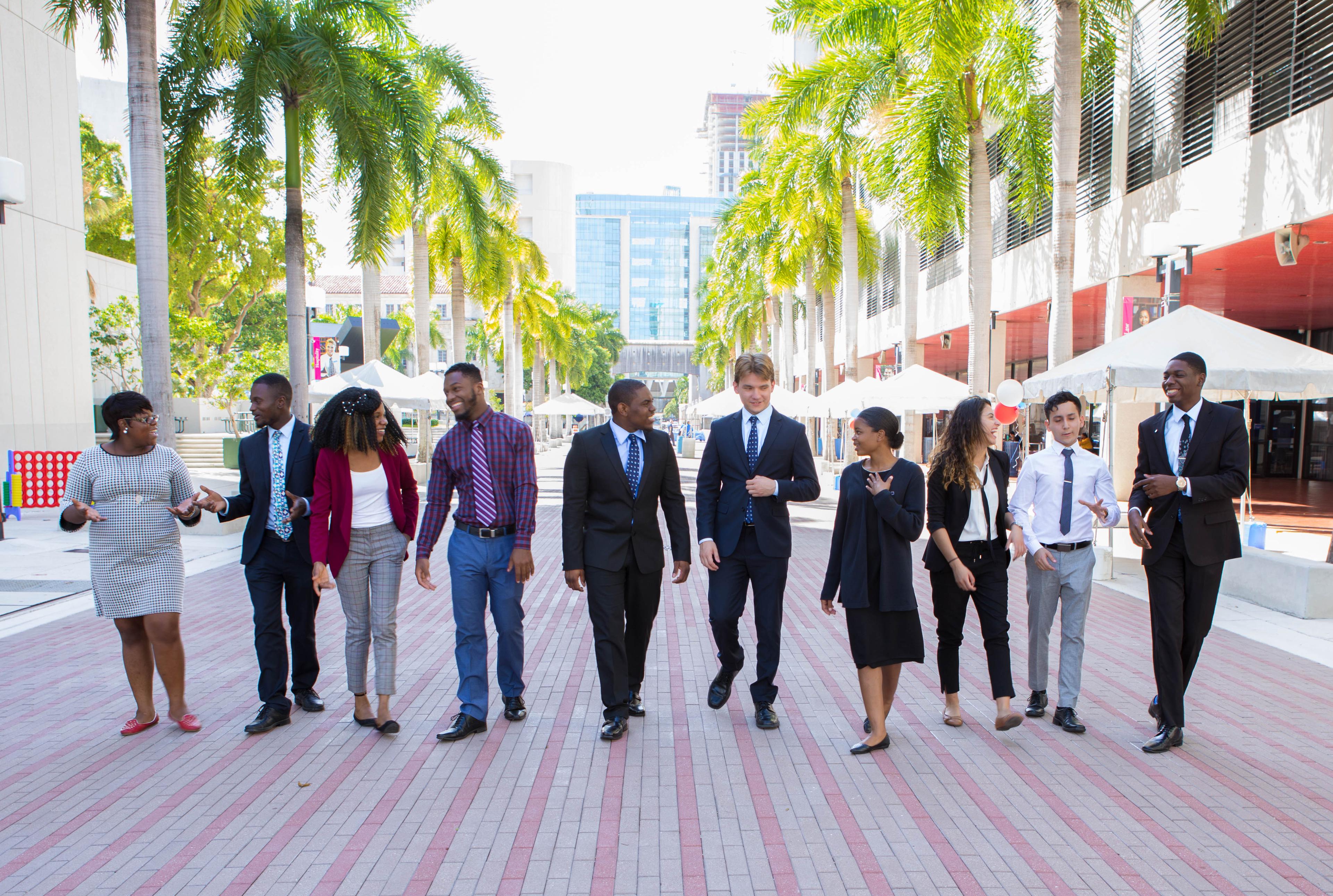 Ten young adults talking and walking outside